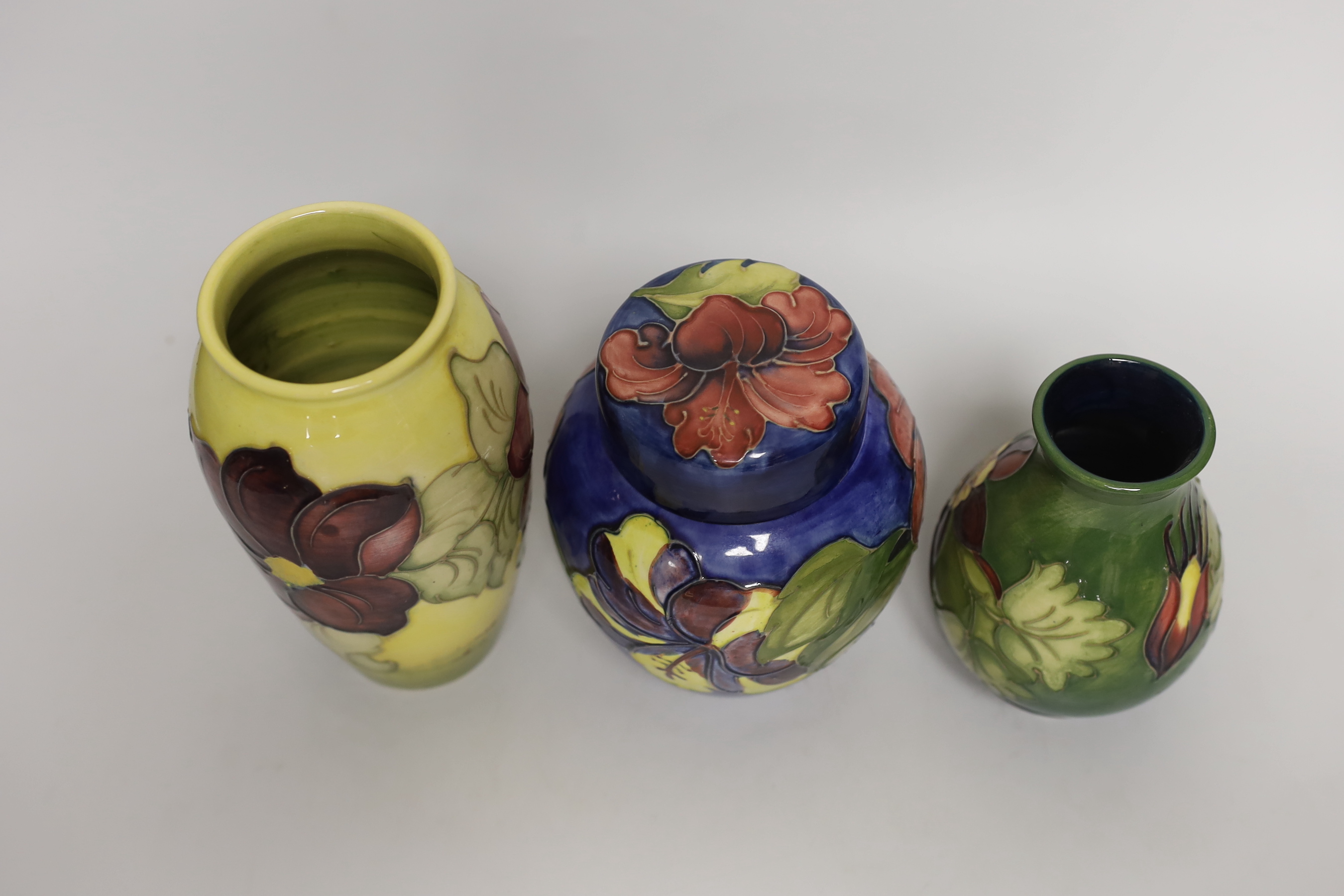 A Moorcroft hibiscus jar and cover, 16cm, an anemone vase and another